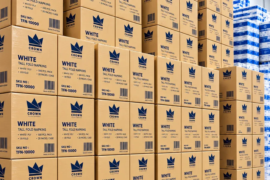 Stacked cases of Crown white tall fold napkins